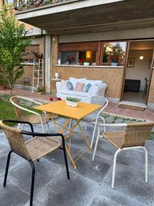 a patio with a table and chairs and a couch at Bed & Coffee Private Parking in Orvieto