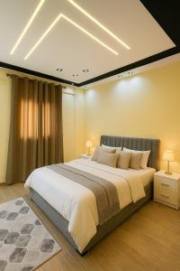 a bedroom with a large bed in a room at Stylish 2BR Flat - El Shorouk, Near Madinaty in Madīnat ash Shurūq