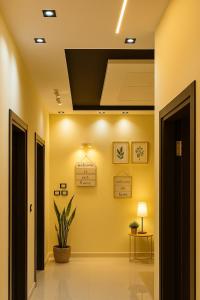 a hallway with yellow walls and a ceiling at Stylish 2BR Flat - El Shorouk, Near Madinaty in Madīnat ash Shurūq