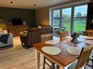 a living room with a table and a couch at Landleeven No11 in Meggerdorf