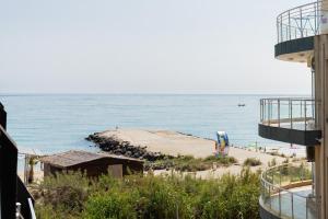 a beach next to the ocean with a building at Marea 1 in Pomorie