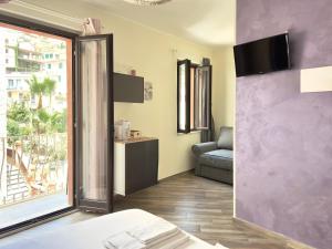 a hotel room with a bed and a window at Poet's rooms in Taormina
