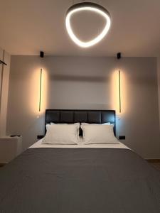 a bedroom with a large bed with a light above it at Casa di Sále in Perea +15 photos