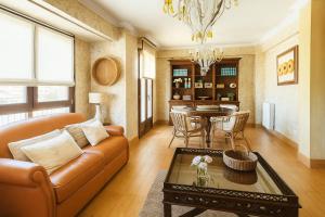 a living room with a couch and a table at Patxiren etxea in Bermeo