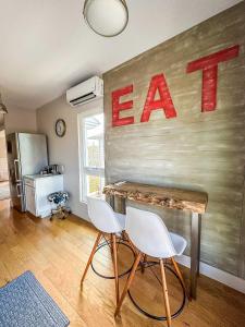 a room with a table and two white chairs at The 4M Favorite House - Stunning & Spotless 2-Bed Apt (#3) in Ann Arbor