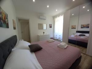 a bedroom with a large bed and a mirror at IL BELVEDERE Guest House in Montefranco