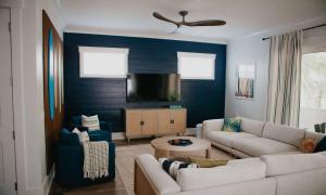 a living room with a couch and a tv at Luxury 6 Br Sleeps 18 Private Heated Pool Fire Pit in Hilton Head Island +76 photos