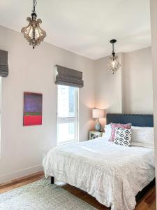 a bedroom with a bed and a chandelier at The 4M Favorite House - Stunning & Spotless 2-Bed Apt (#1) in Ann Arbor