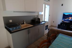 a kitchen with a sink and a counter top at Studio du Bonheur in Azur