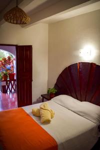 a bedroom with a large bed with towels on it at Hotel Posada Santa Anita in Taxco de Alarcón