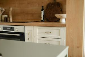 a kitchen with white cabinets and a counter top at Edison Villa 214 in Fonyód
