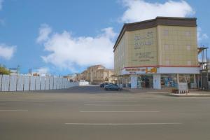 a building with a car parked in front of a street at فندق ليوان ان Liwan Inn HOTEL in Jazan