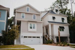 a white house with a white garage at Luxury 6 Br Sleeps 18 Private Heated Pool Fire Pit in Hilton Head Island