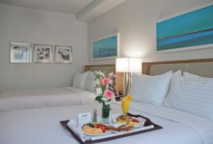 a hotel room with a tray of food on a bed at Holiday Inn Washington-Central/White House by IHG in Washington, D.C.