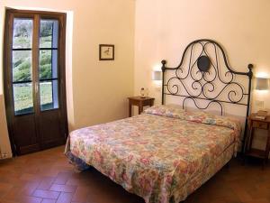 a bedroom with a bed and a window and a door at Agriturismo Castagna Alta in Valfabbrica