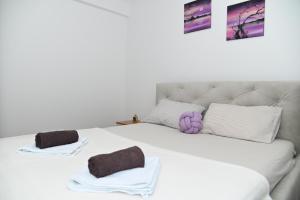 a white bed with two pillows on top of it at Apartman TEA Trebinje in Trebinje