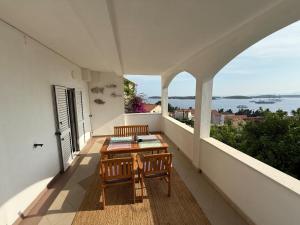 a balcony with a table and a view of the ocean at Apartments Biba Hvar in Hvar +50 photos