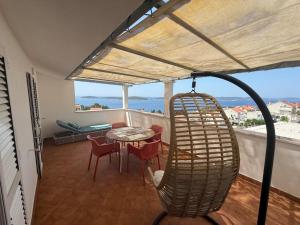a room with a balcony with a table and chairs at Apartments Biba Hvar in Hvar
