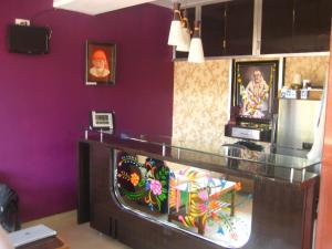 a room with a counter with purple walls at Hotel Yogiraj in Shirdi
