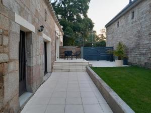 a courtyard of a building with a patio and grass at Villa Monica in Baud