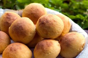 a bunch of bread rolls in a bowl at Hotel Bühler in Visconde De Maua