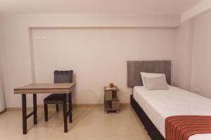 Postel nebo postele na pokoji v ubytování Sumaq Cusco Suites