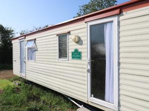 a white trailer with a sign on the side of it at Freesia in Northampton