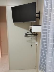 a flat screen tv sitting on top of a wall at Ilone de Fátima Wagner in Chapecó