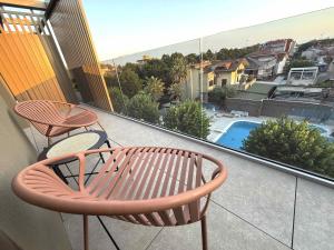 a balcony with a bench and a view of a pool at Suite Apartments Prestige in Bellaria-Igea Marina