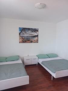 Postel nebo postele na pokoji v ubytování ApartmaniNET