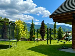 a yard with a swing set and a playground at Apartmány Roháče in Zuberec