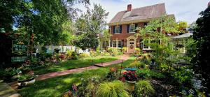 a garden in front of a house with flowers at Pettigru Place Bed & Breakfast in Greenville