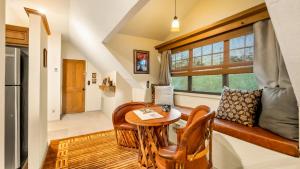 a living room with a table and a couch and a window at Tubac Country Inn in Tubac