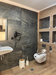 a bathroom with a toilet and a sink at Akti Vigla Premium in Mytilene +126 photos