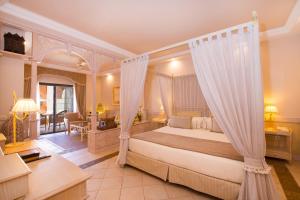 a hotel room with a large bed and a large window at Iberostar Grand El Mirador - Adults Only in Adeje