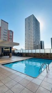 a swimming pool on top of a building with tall buildings at Liza Luxury Holiday Apartment Oceanic 44 in Durban