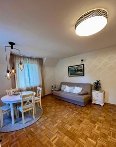 a living room with a couch and a table at Oaza Narave in Spodnje Gorje