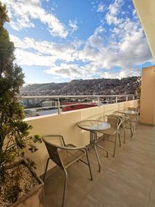 a balcony with tables and chairs and a view at Suites Cusco in Cusco