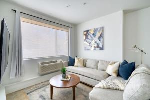 a living room with a couch and a table at Studio Bliss Dual-Queen Stay in Vibrant Alberta in Portland