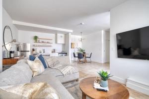 a living room with a couch and a table at Studio Bliss Dual-Queen Stay in Vibrant Alberta in Portland