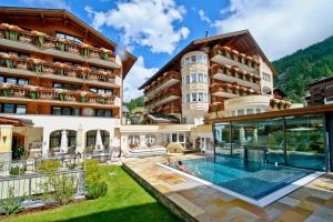 an image of a hotel with a swimming pool at Resort La Ginabelle in Zermatt
