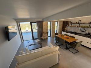 una sala de estar con un sofá y una mesa en Sunrise Village Aptera Private Pool Villa, en Beritianá 37 fotos más