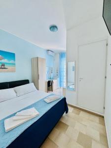 a bedroom with a bed with towels on it at Dimora Il Girasole in Torre San Giovanni Ugento