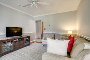 a living room with a couch and a flat screen tv at Brand-New Pool! Waterfront Bozman Village Home 