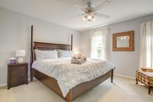 a bedroom with a bed and a ceiling fan at Brand-New Pool! Waterfront Bozman Village Home  +37 photos