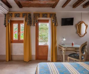 TV a/nebo společenská místnost v ubytování Hotel Il Mercante di Venezia