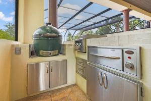 a kitchen with a grill and a large pot at Sparkling Pool Balcony Sunsets Pool Table Dock in Saint Augustine