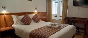 Rúm í herbergi á Saphi Inn Cusco - Excelente ubicación