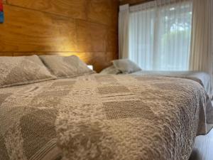 Voodi või voodid majutusasutuse Verdevida Apart Hotel toas