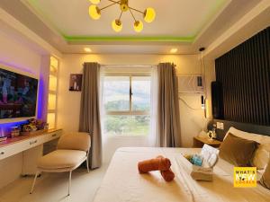 Μια τηλεόραση ή/και κέντρο ψυχαγωγίας στο Solaria Haven Cozy & Family Friendly Studio in Bacolod